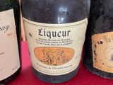 three bottles of wine sitting on a table with a red cloth