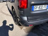 a man taking a picture of a car with his cell phone
