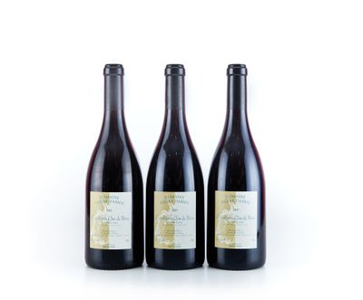 trois bouteilles de vin sont alignées sur une surface blanche