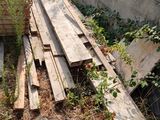 a pile of wood sitting on the ground next to a building