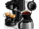 a coffee maker and two cups of coffee next to each other