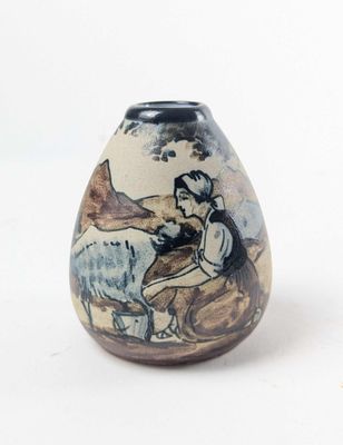 a small vase with a picture of a woman and a dog on it
