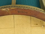 an image of a close up of a wooden chair with a leather seat