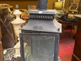 a small lantern sitting on top of a table in a room