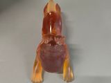 a glass figurine of a dog sitting on top of a table