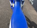 a blue and white motorcycle parked on the side of the road