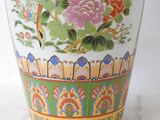 a vase with a bird on it sitting on a table