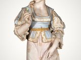 an image of a figurine of a woman in a pink dress