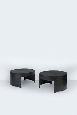 deux tables noires posées sur un sol blanc