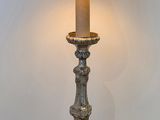 a lamp that is sitting on the floor next to a wall