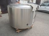 a man standing next to a large metal container