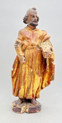 statue of a man in a yellow robe holding a fan