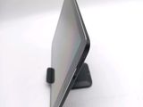 a tablet computer sitting on a stand on a white surface