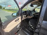 a car with the door open on the side of the road