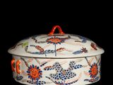 an image of a white and orange bowl with flowers on it