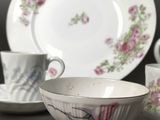 three cups and a saucer sitting on a table