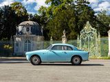 a blue car that is parked in front of a gate