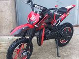 a red dirt bike parked in front of a garage door