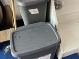 two trash cans sitting next to each other on the floor