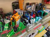 many pens and pencils in the bins on the shelf