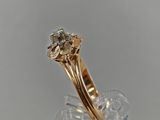 a close up of a gold ring with a diamond on top of it