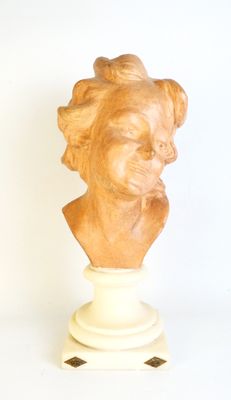 sculpture of a woman ' s head on a pedestal on a white background