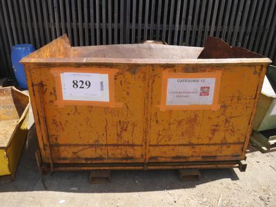 a large yellow dumpster sitting in front of a building