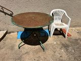 two chairs and a table on the concrete ground