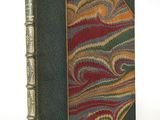 an old book with a green cover and a red, yellow, and green design