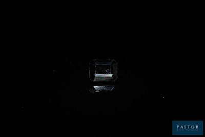 a small window in the dark with a clock on it