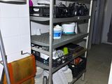 a metal rack with many items on it in a kitchen
