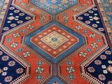an image of a blue and red rug with a diamond design