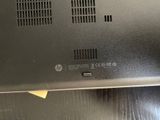 someone is holding a laptop that is sitting on a table