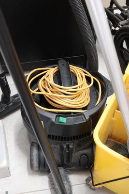 a yellow bucket with a yellow hose and a yellow bucket with a yellow hose