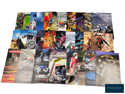 a lot of posters of different motorcycles on a table