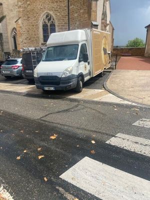 a white van that is parked on the side of the road