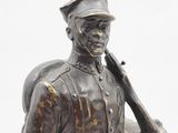 bronze statue of a soldier holding a baseball bat on a white background