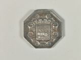 a silver coin with a picture of a coat of arms on it
