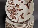 a stack of plates with brown leaves on them