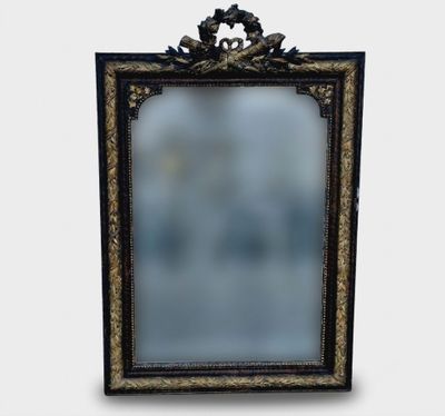 a black and gold frame with a mirror on it