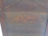 a wooden cabinet that has a door on it