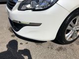 a white car parked in a parking lot with other cars in the background