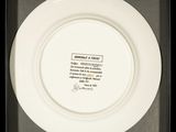 a white plate with a picture on it in a black box