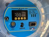 a close up of a blue and yellow clock on a plastic container