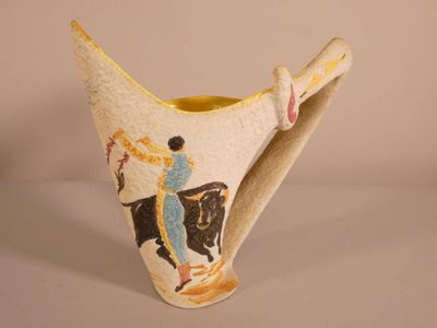 a vase with a picture of a man riding a horse