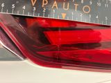 a close up of a car tail light with a ruler