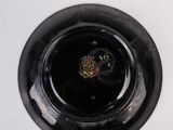 a black vase with a gold emblem on it