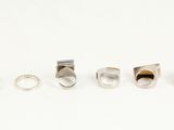 five different rings are arranged in a row on a white surface