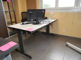 a desk with a computer monitor and a laptop on it
