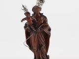 a statue of a woman holding a baby and a crown